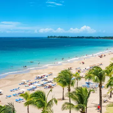 Puerto Rico beach travel vacation landscape background. Isla Verde resort in San Juan, famous tourist cruise ship destination in the Caribbean.