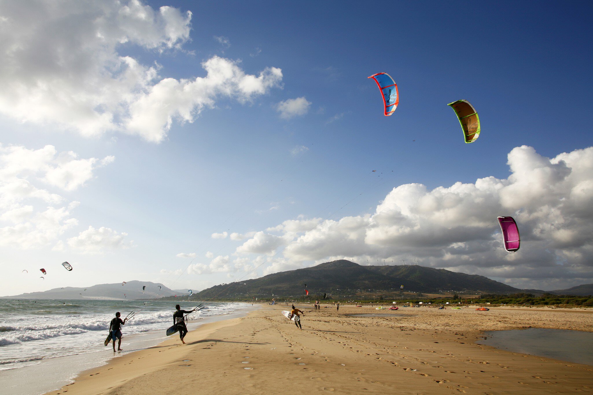 Kite surfers on Playa de los Lances on a sunny day along the Costa de la Luz in Spain.
