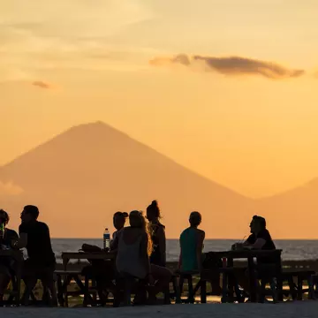 People on Gili Trawangan watching a sunset with a view of the Gunung Agung volcano