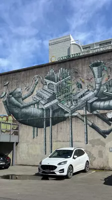 A large mural of a person playing with a steampunk-style musical instrument