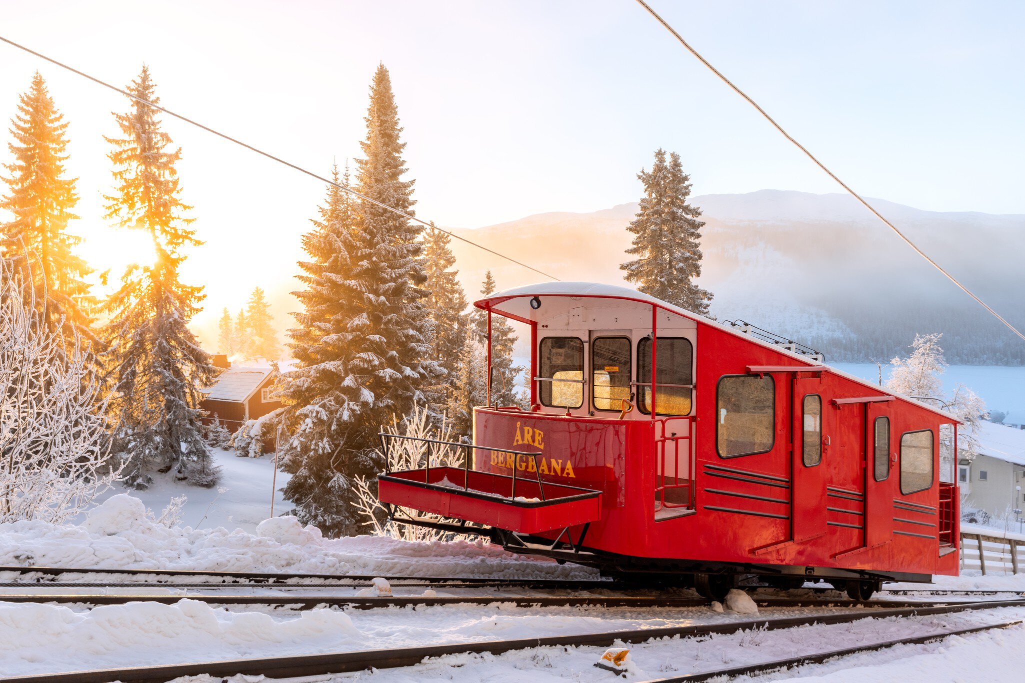 Åre, Sweden - Dec 14, 2018: A red trolley at the mountain railroad at the ski resort Åre in Sweden, opened 1908 as the first permanent connection up to the mountain.; Shutterstock ID 1259682724;