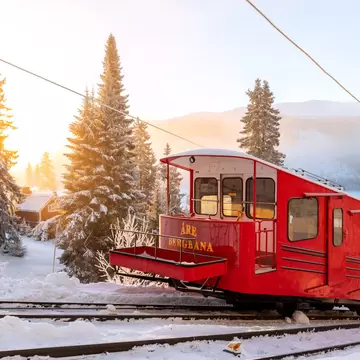 Åre, Sweden - Dec 14, 2018: A red trolley at the mountain railroad at the ski resort Åre in Sweden, opened 1908 as the first permanent connection up to the mountain.; Shutterstock ID 1259682724;
