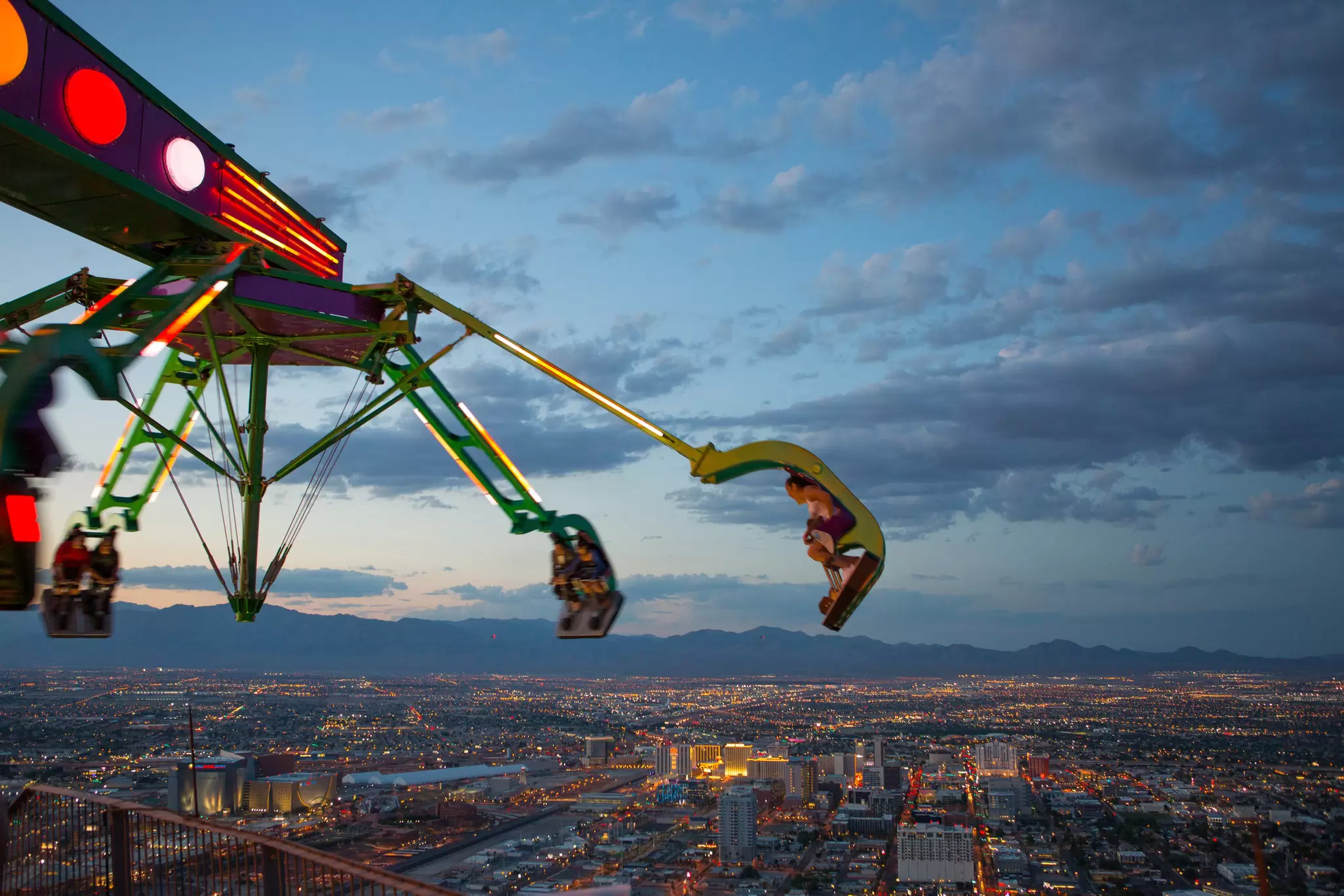 Insanity, a green claw-like ride swings out into the sky on top of the STRAT hotel in Las Vegas.
