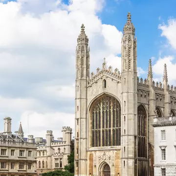 View inside Kings college Chapel Cambridge, showing the fan vault ceiling and vast wooden paneling, and amazing stain glass windows.