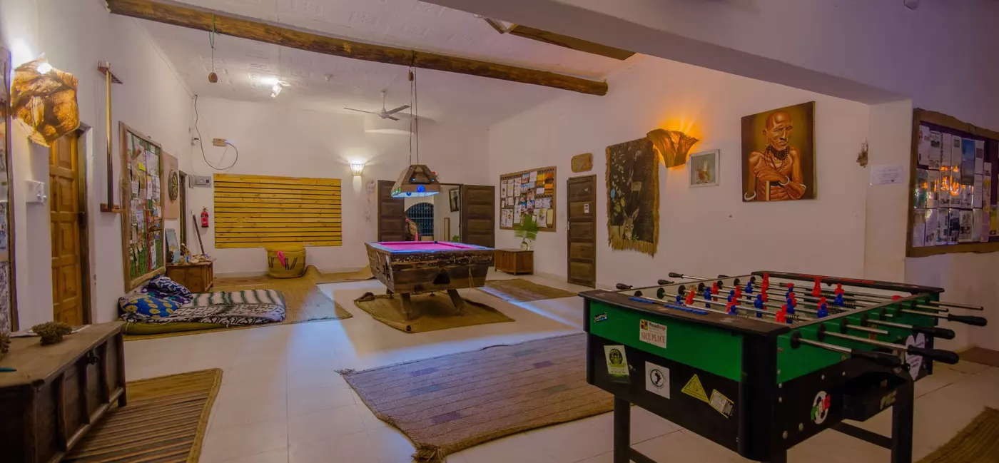 A large common room with table football and a pool table.