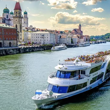 A cruise ship passes by Passau, Bavaria, on the Danube River. FooTToo/Shutterstock