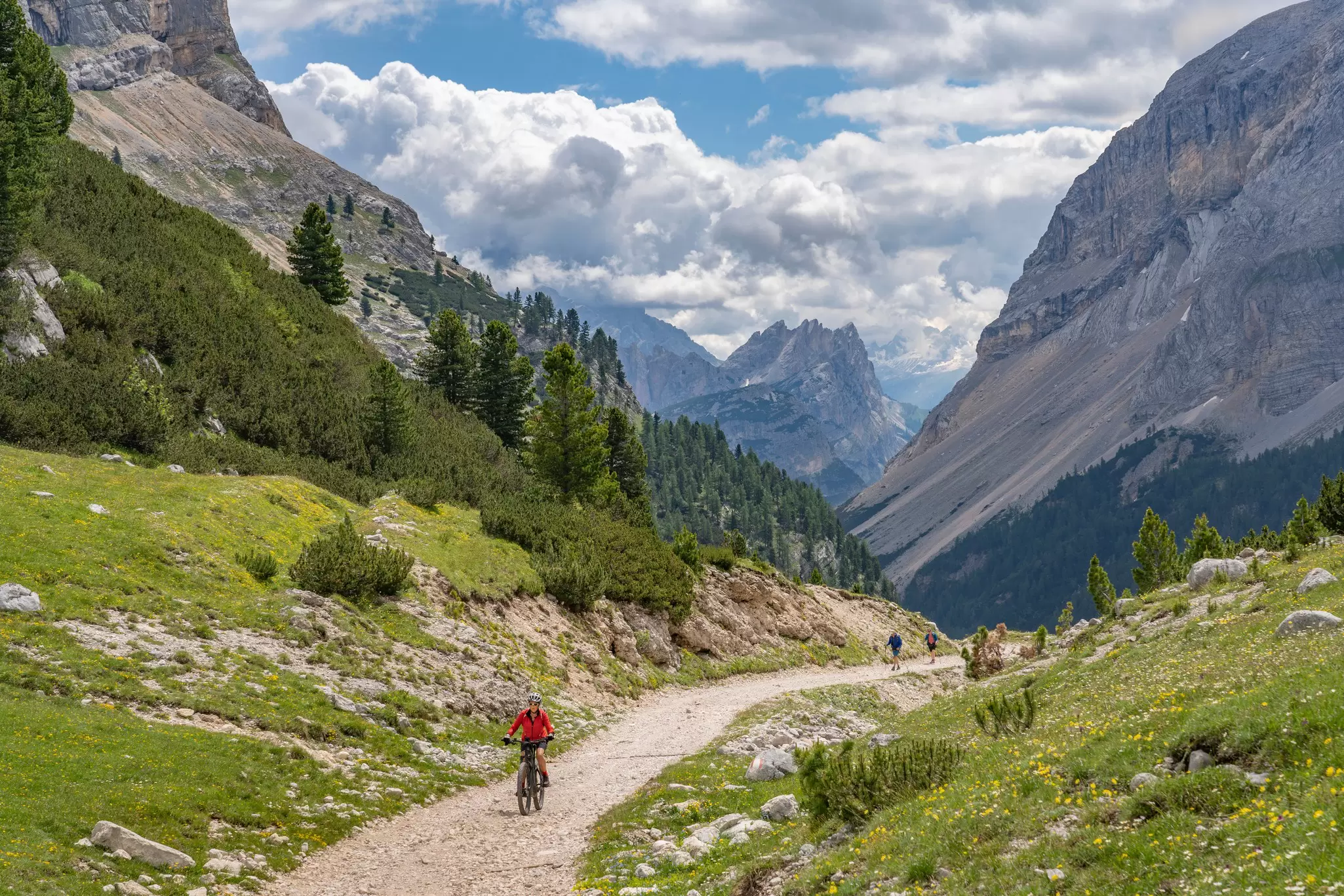 A woman riding her bike on a moutain path