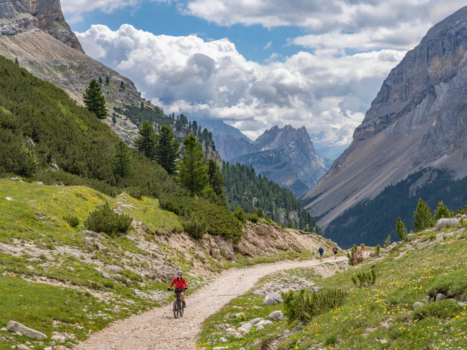 A woman riding her bike on a moutain path