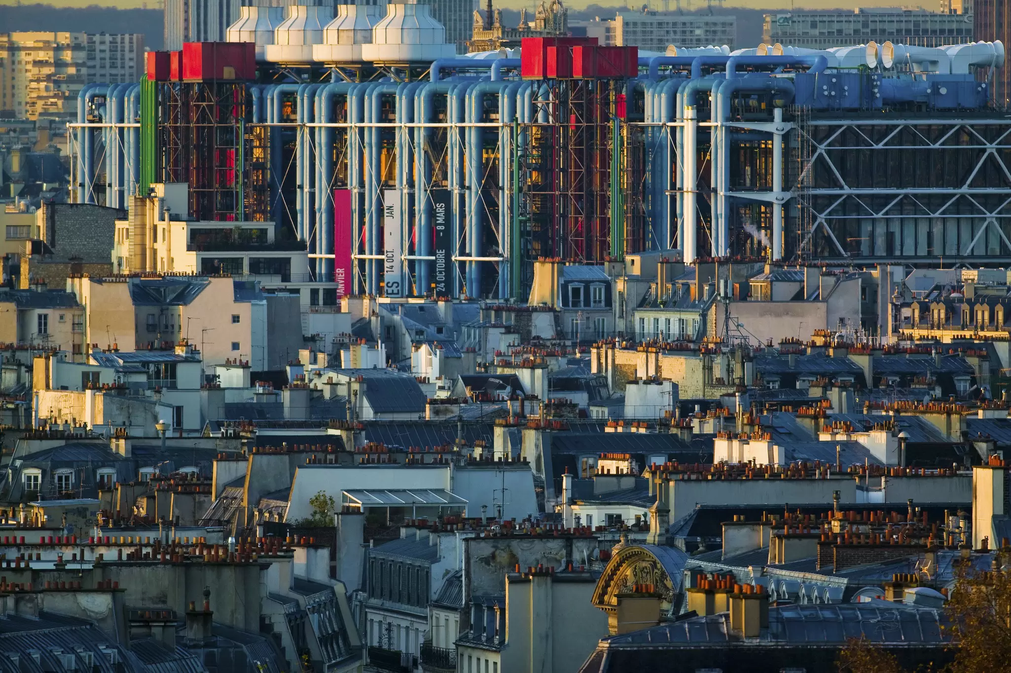 The brightly coloured Centre Pompidou rising above a dense sea of grey Parisian rooftops