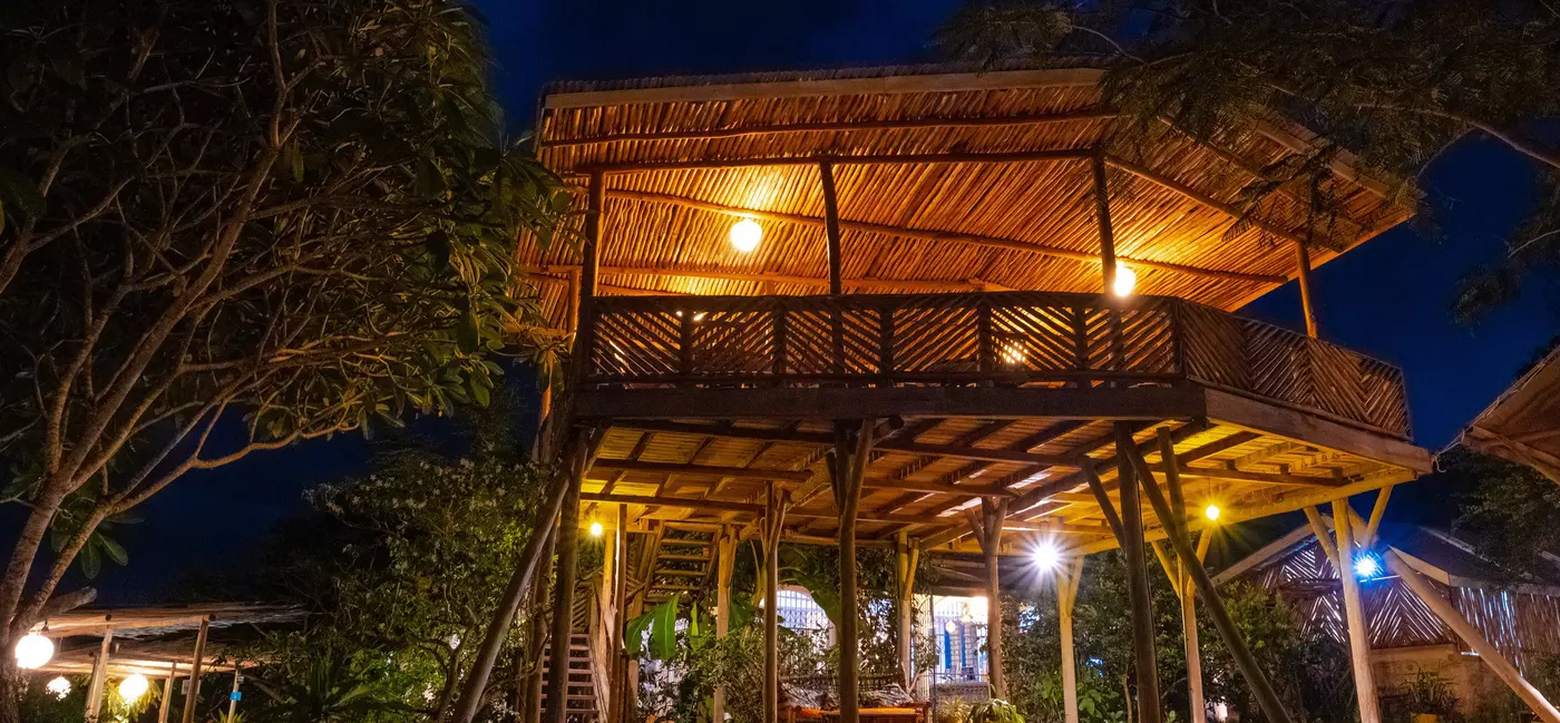 A wooden structure on stilts at night.