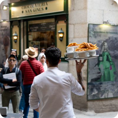 A server carries a tray to a table