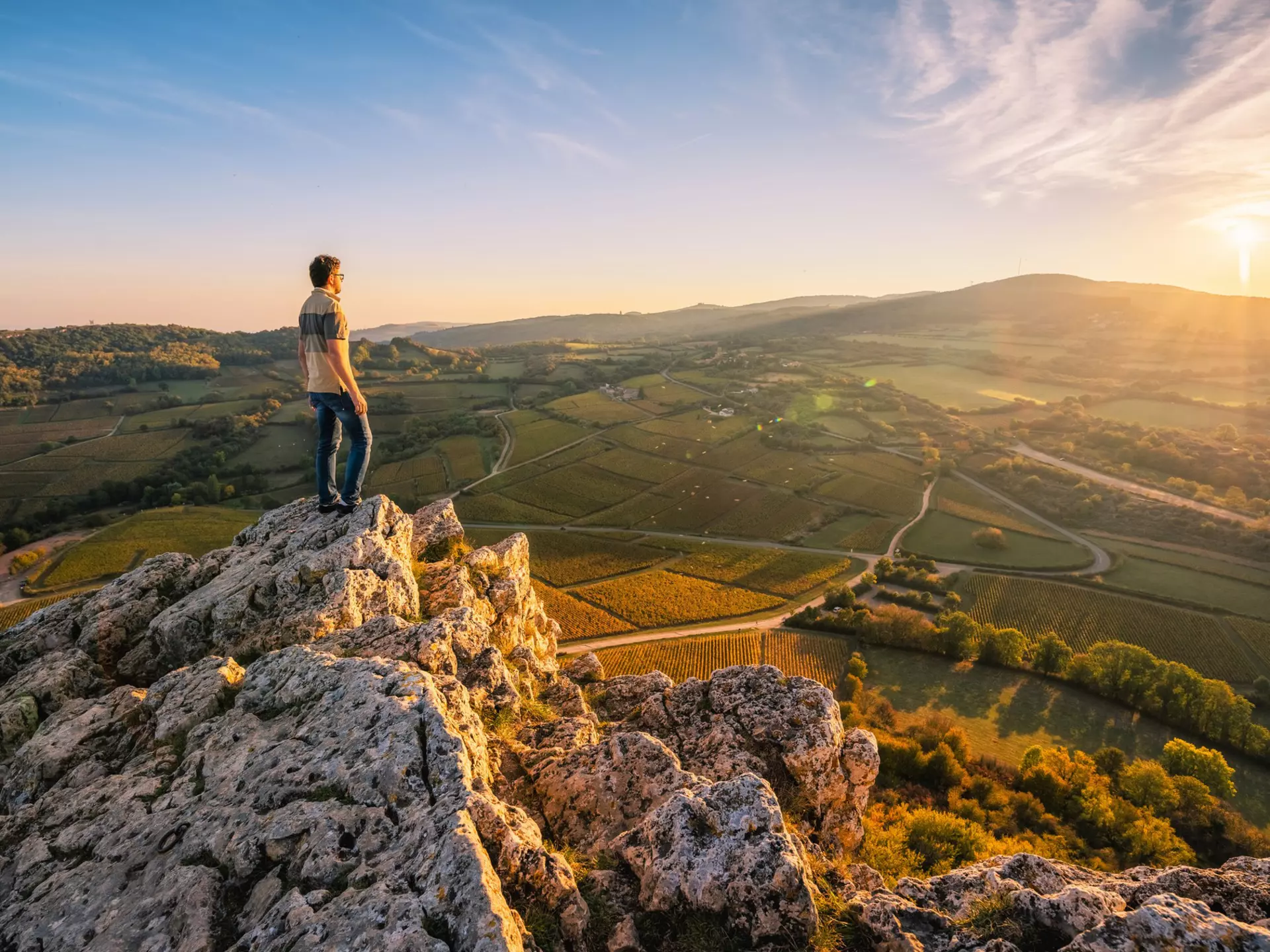 Man standing on the Rock of Solutre at sunset, Burgundy