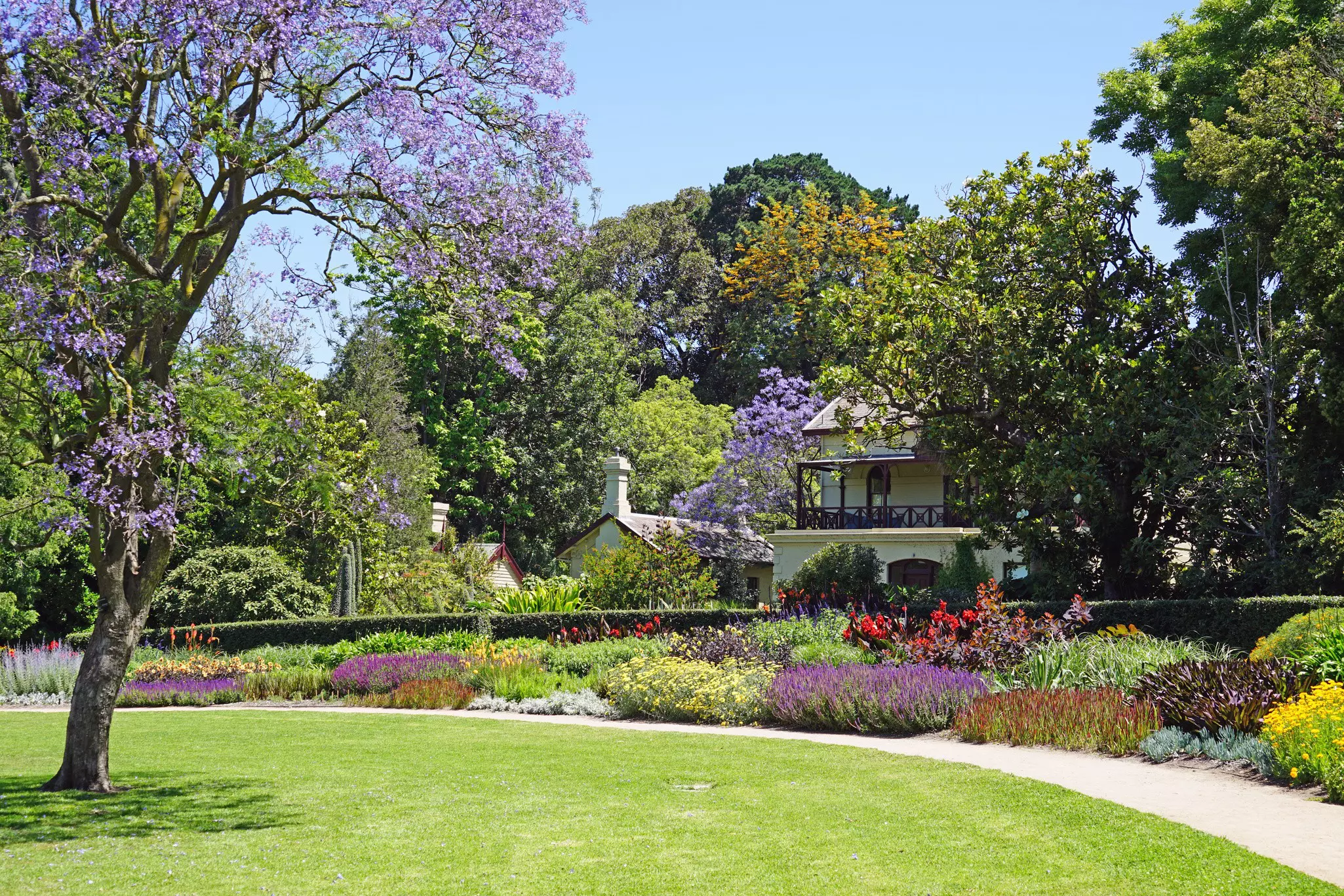 The Royal Botanic Gardens is located in the center of Melbourne by the Yarra River. It includes a herbarium and a children's garden.