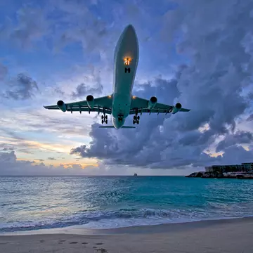 Air France plane landing at Princess Juliana International Airport (PJIA) at sunset on St.Maarten.