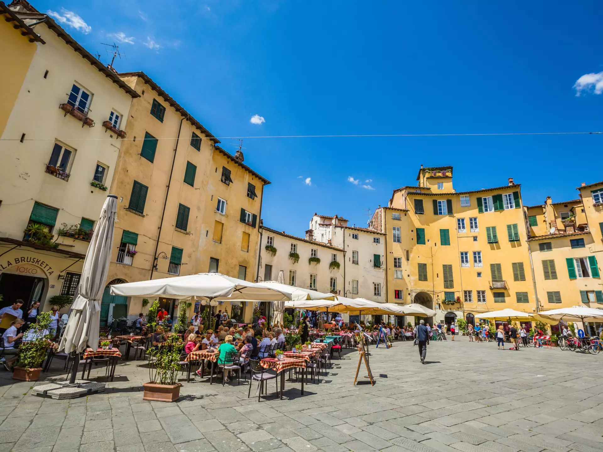 Dining on Piazza dell'Anfiteatro in Lucca, Tuscany. Paradise at risk/Shutterstock