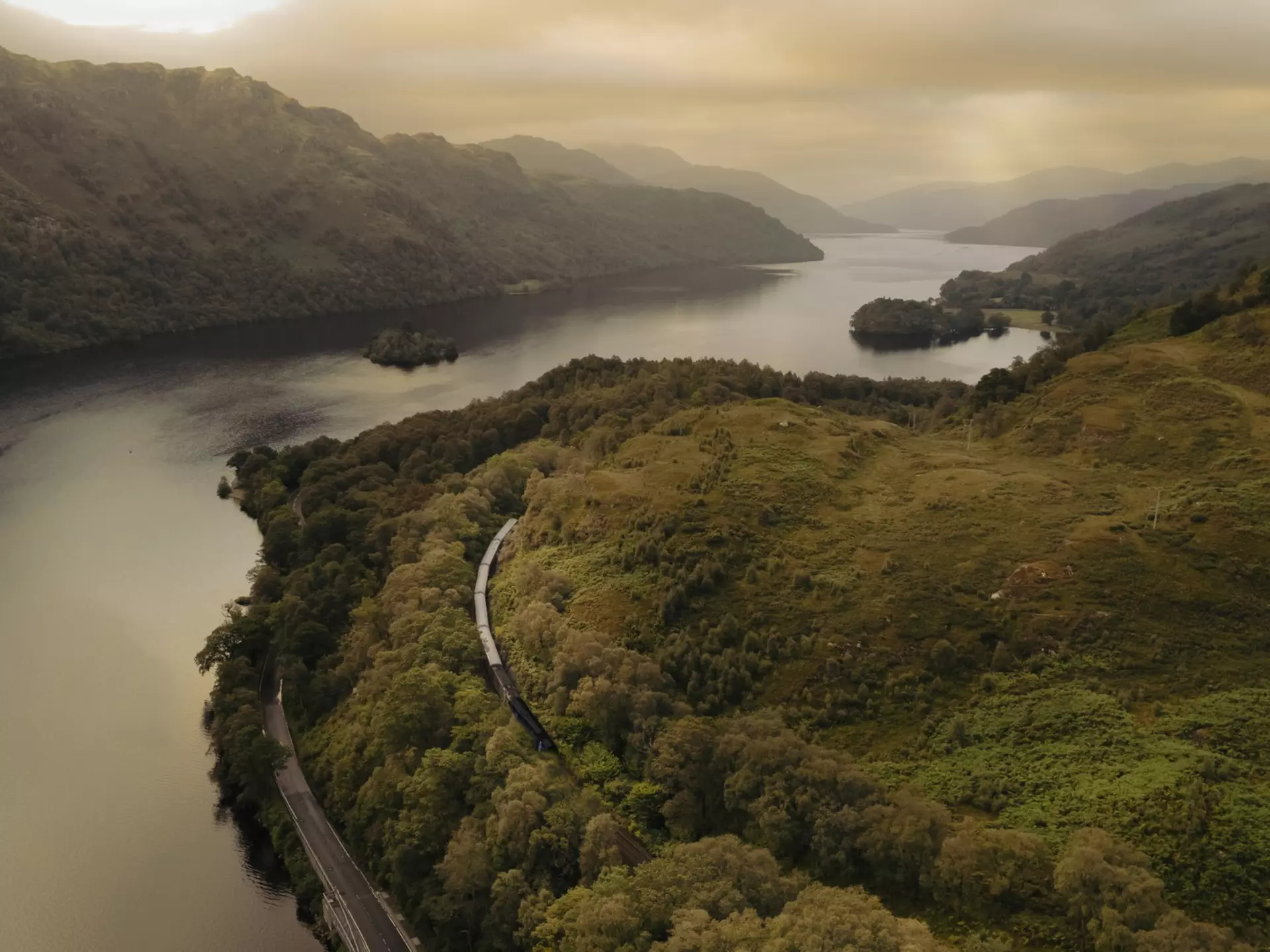 The Caledonian Sleeper crawls past Loch Lomond in Scotland. Caledonian Sleeper