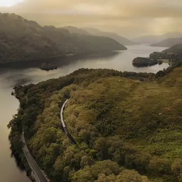 The Caledonian Sleeper crawls past Loch Lomond in Scotland. Caledonian Sleeper