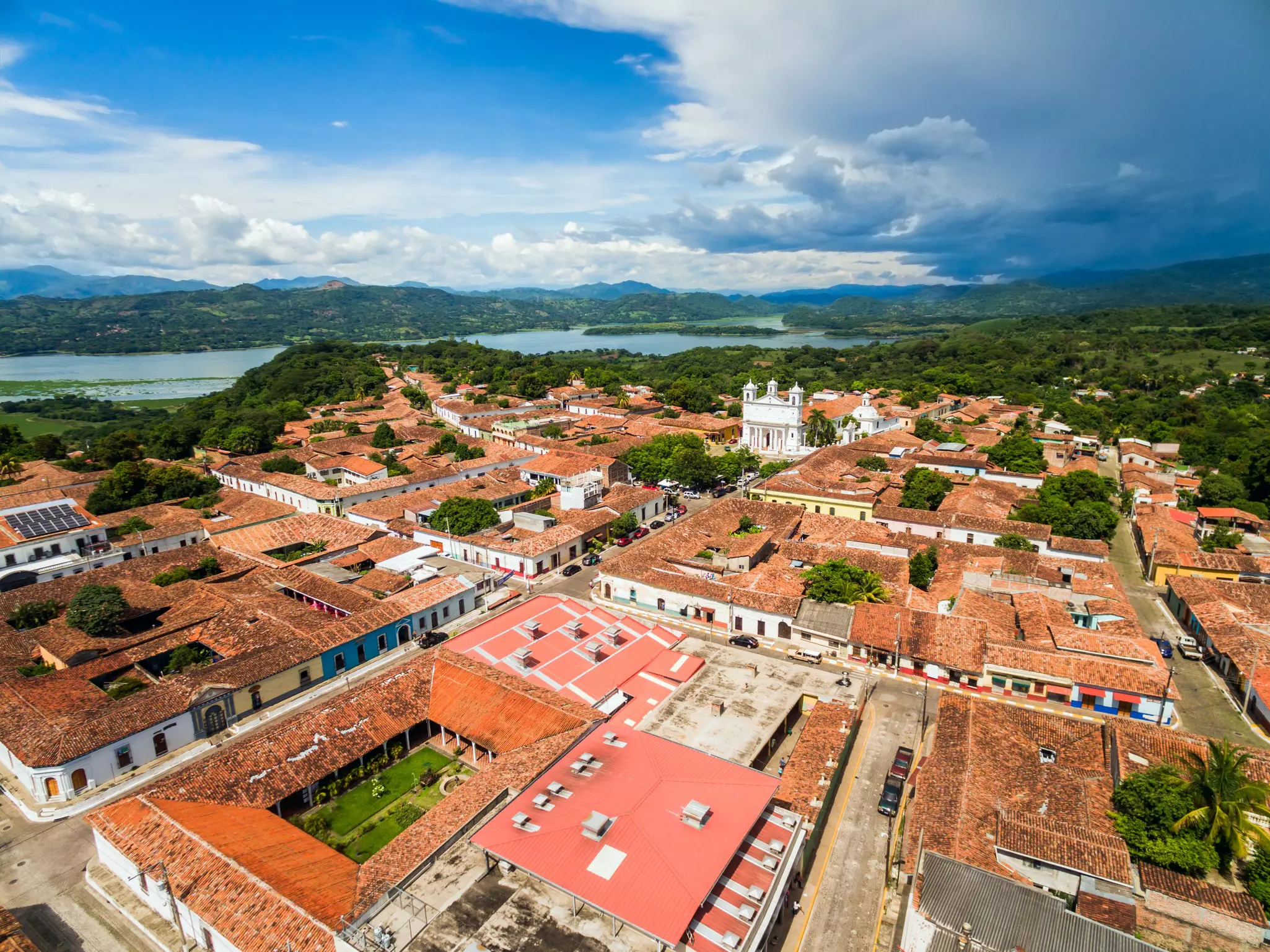 An aerial view of the historic and colonial town of Suchitoto with the Lempa river behind in El Salvador,