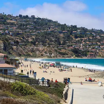 a beautiful summer landscape at Burnout Beach with blue ocean water, people relaxing in the sand, blue sky and clouds in Redondo Beach California USA, License Type: media, Download Time: 2026-08-05T17:13:47.000Z, User: LP_NZhan, Editorial: false, purchase_order: 65050 - Digital Destinations and Articles, job: App Content, client: Lonely Planet, other: Nadine Zhan 