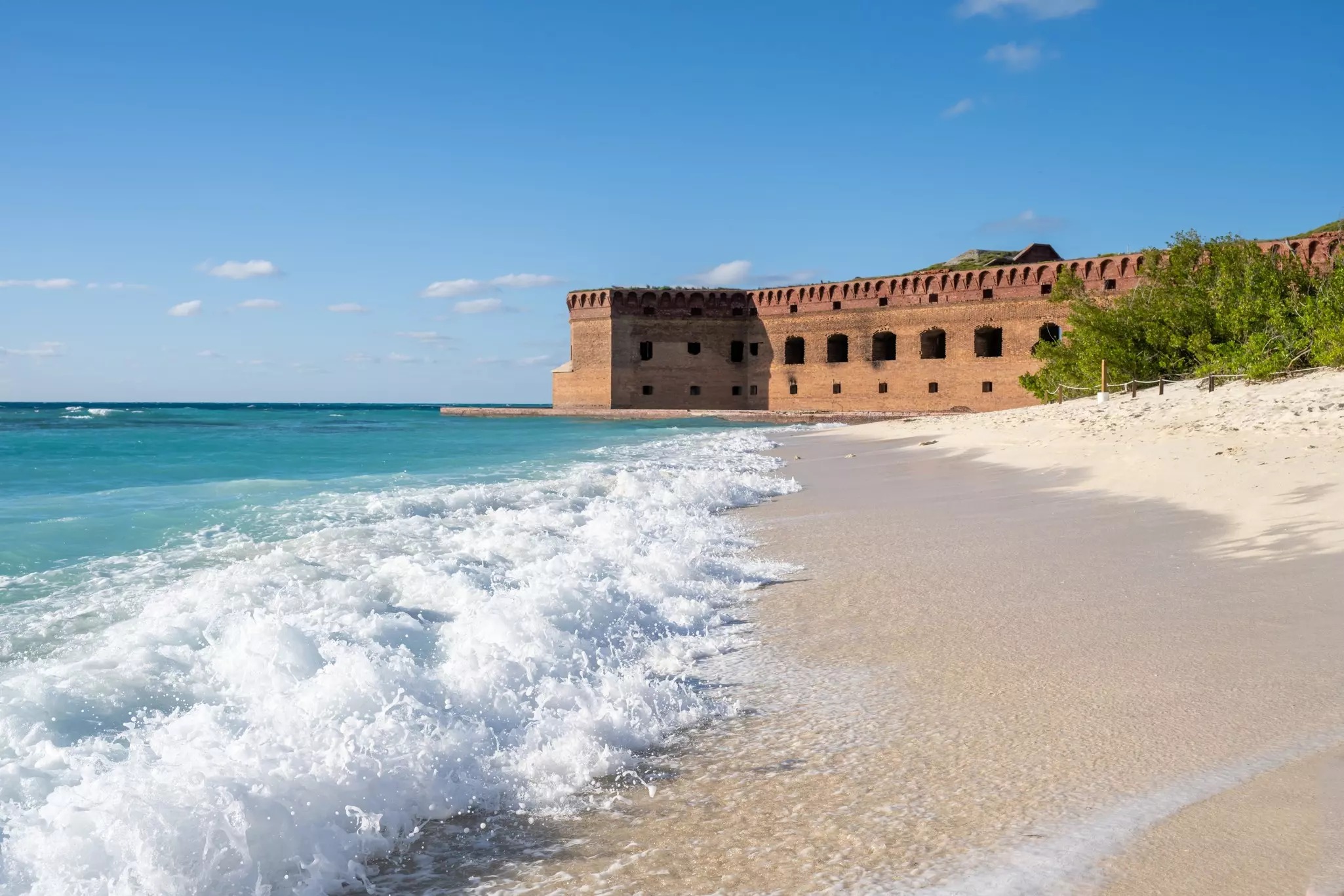 Waves crashing onto the empty beach next to Fort Jefferson. Lost_in_the_Midwest/Shutterstock
