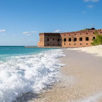 Waves crashing onto the empty beach next to Fort Jefferson. Lost_in_the_Midwest/Shutterstock