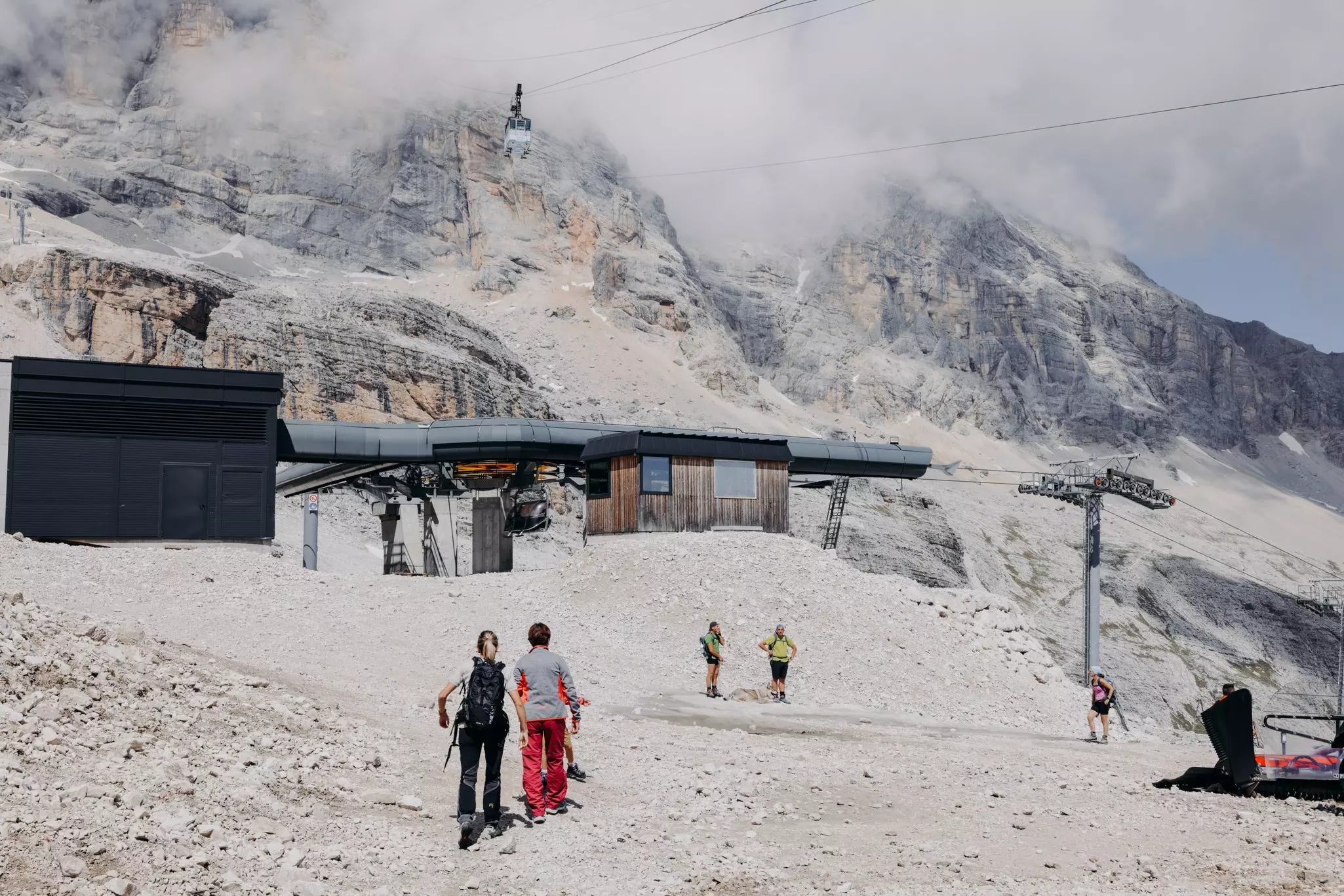 Hikers by the top station of the Freccia nel Cielo in the Dolomites near Cortina d'Ampezzo, Italy.