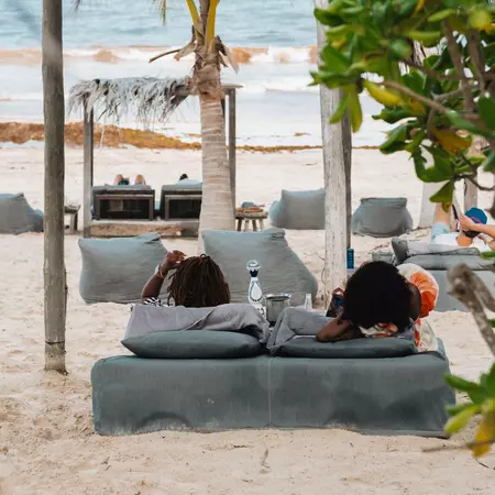 Two people lounging at at Nômade Temple Tulum