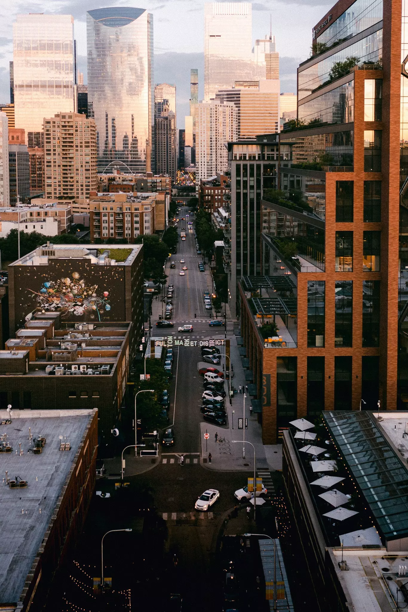 Aerial view of a street in Chicago's West Loop neighborhood, with a wide road leading to skyscrapers.
