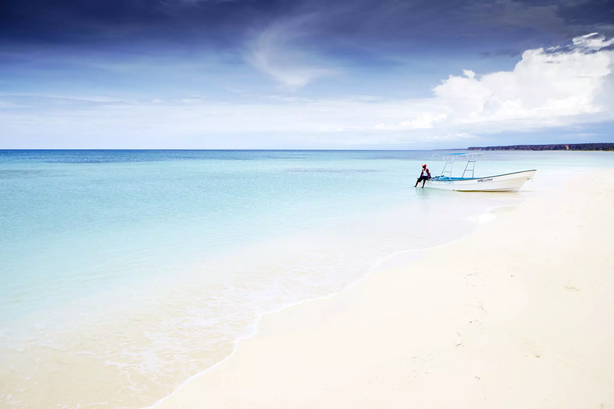 A fisherman moors his boat just off the pristine sands of Bahía de Las Águilas. Matt Munro for Lonely Planet