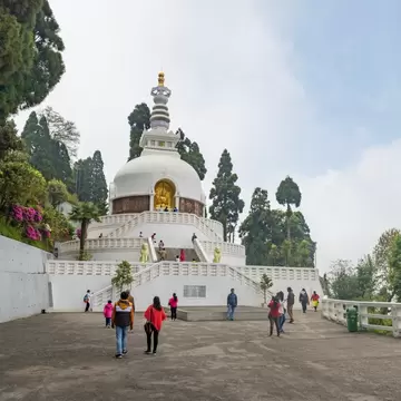 People walking by the Japanese World Peace Pagoda. Darjeeling, India.