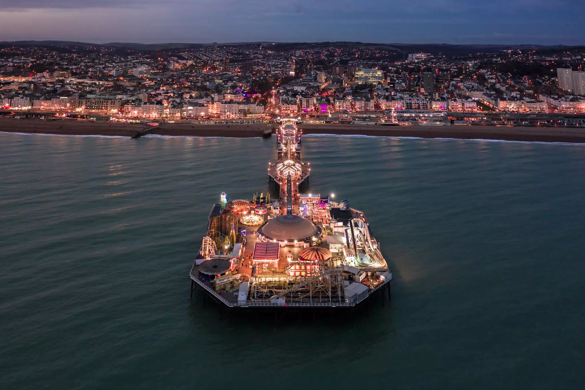 Brighton Palace Pier and Seafront Illuminated at Night on the South Coast of England