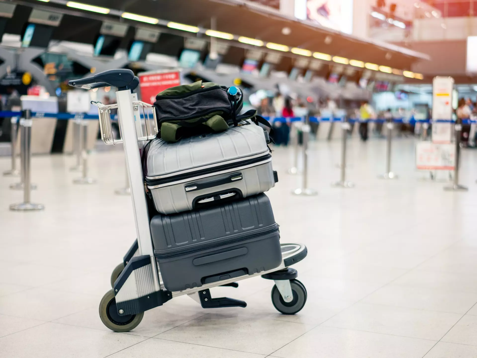 Suitcase or baggage with airport luggage trolley in the international airport.