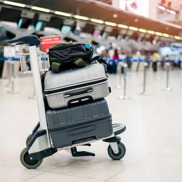Suitcase or baggage with airport luggage trolley in the international airport.