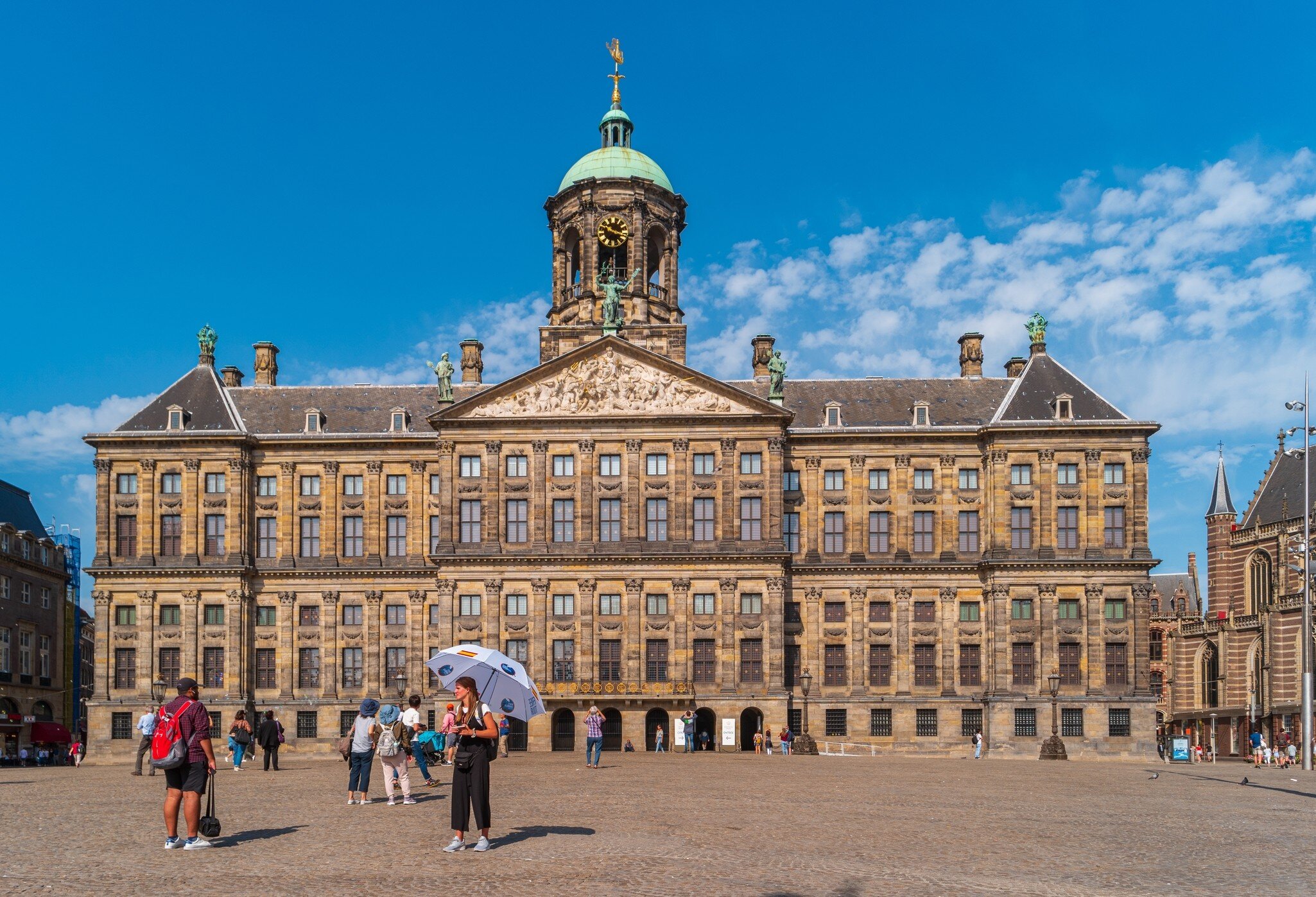 View of the Royal Palace from Dam Square in Amsterdam on a sunny day.