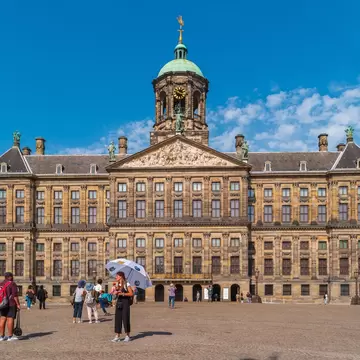 View of the Royal Palace from Dam Square in Amsterdam on a sunny day.