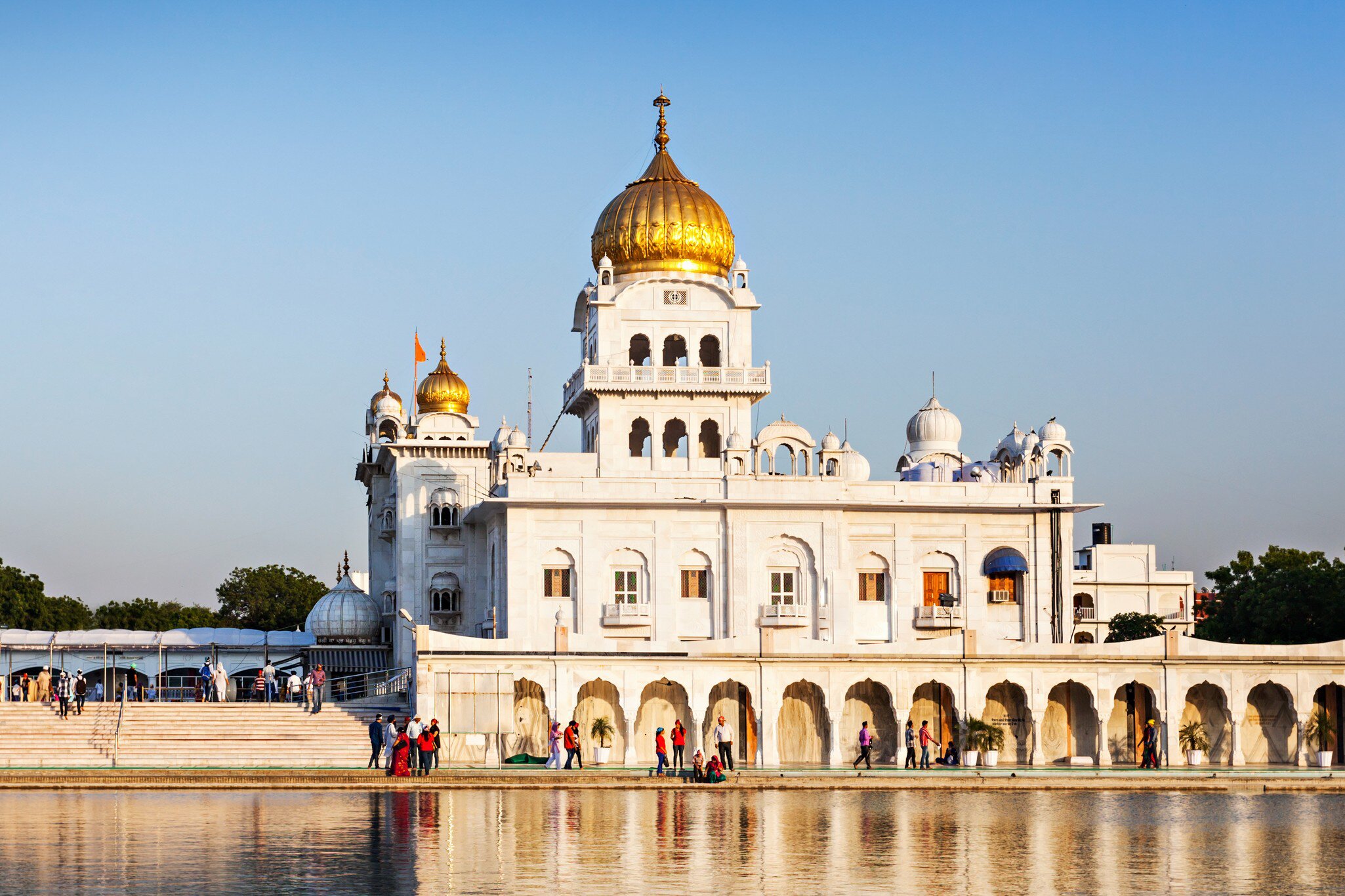 Exterior of the Gurdwara Bangla Sahib during the day.
569575438
amrit, amritsar, ancient, architecture, asia, asian, bangla, building, capital, cupola, day, delhi, dome, exterior, faith, gold, golden, gurdwara, guru, gurudwara, har, hinduism, historic, holy, icon, important, india, indian, krishan, landmark, marble, monument, most, new, nishan, old, people, place, pond, religion, sahib, sarovar, shrine, sikh, sikhism, temple, tourism, tourist, travel, worship