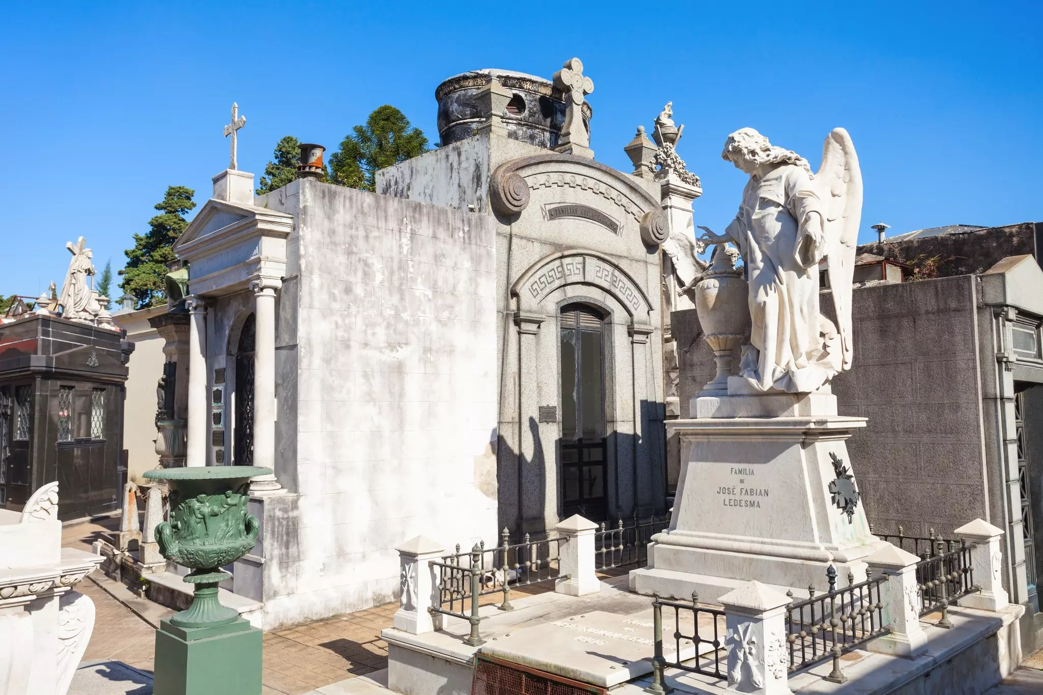 Large marble mausoleums with angel statues at Cementerio de la Recoleta Buenos Aires.