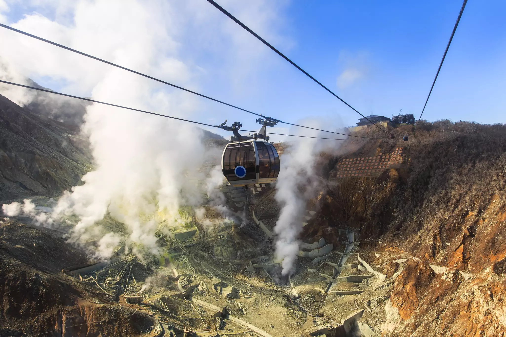The Hakone Ropeway climbs above the steam vents of the volcanic Owakudani valley in Hakone, Japan.