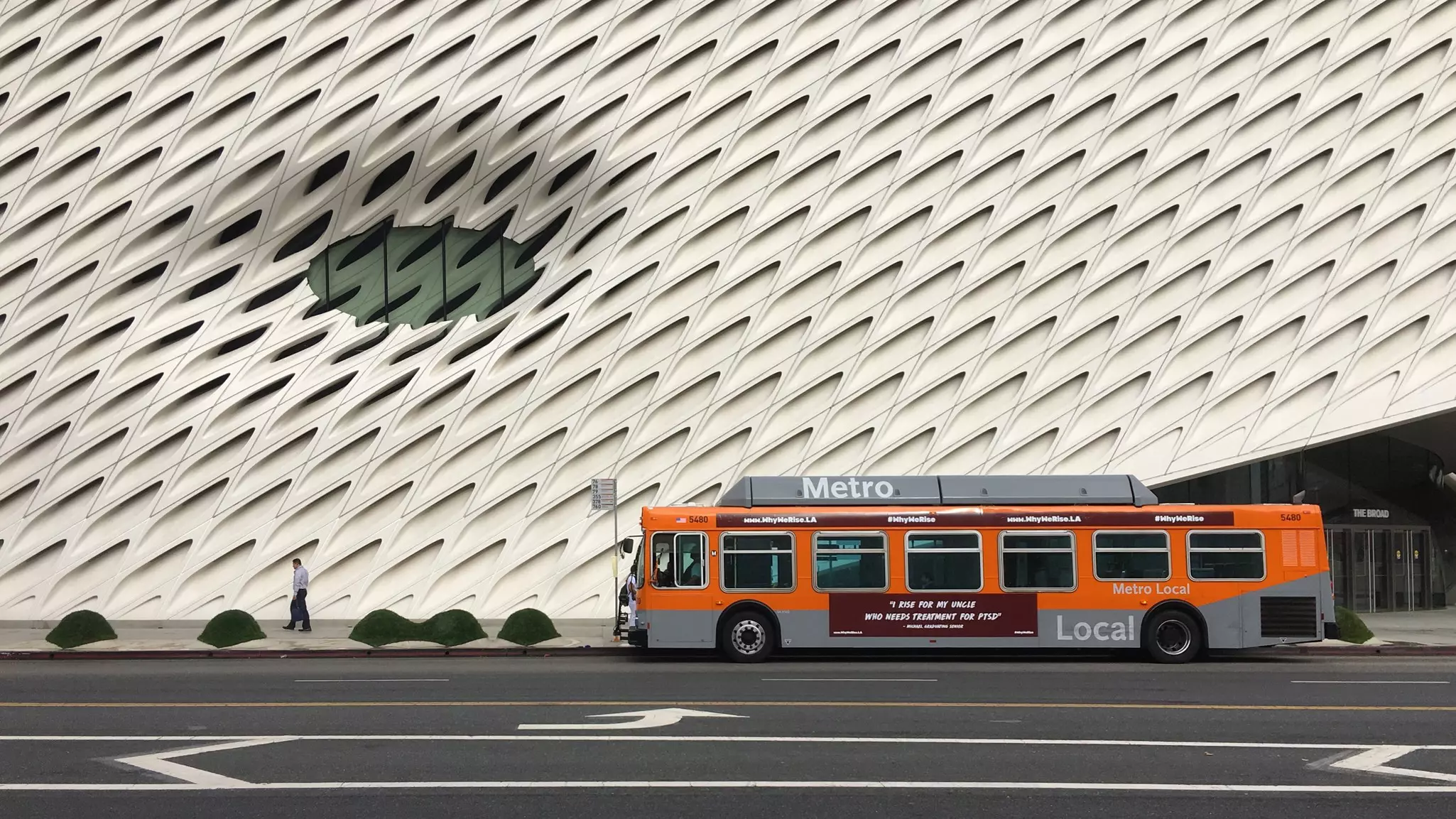 LOS ANGELES, CA, OCT 2018: LA Metro bus stopped with pedestrian walking past outside The Broad museum in Downtown Los Angeles  License Type: media  Download Time: 2024-01-17T18:12:34.000Z  User: bhealy950  Is Editorial: Yes  purchase_order: