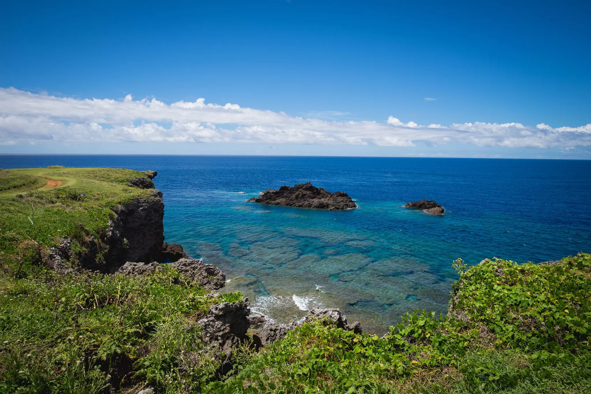 A rocky coastline of a green island.