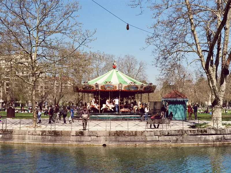 Carousel in a city park near a canal