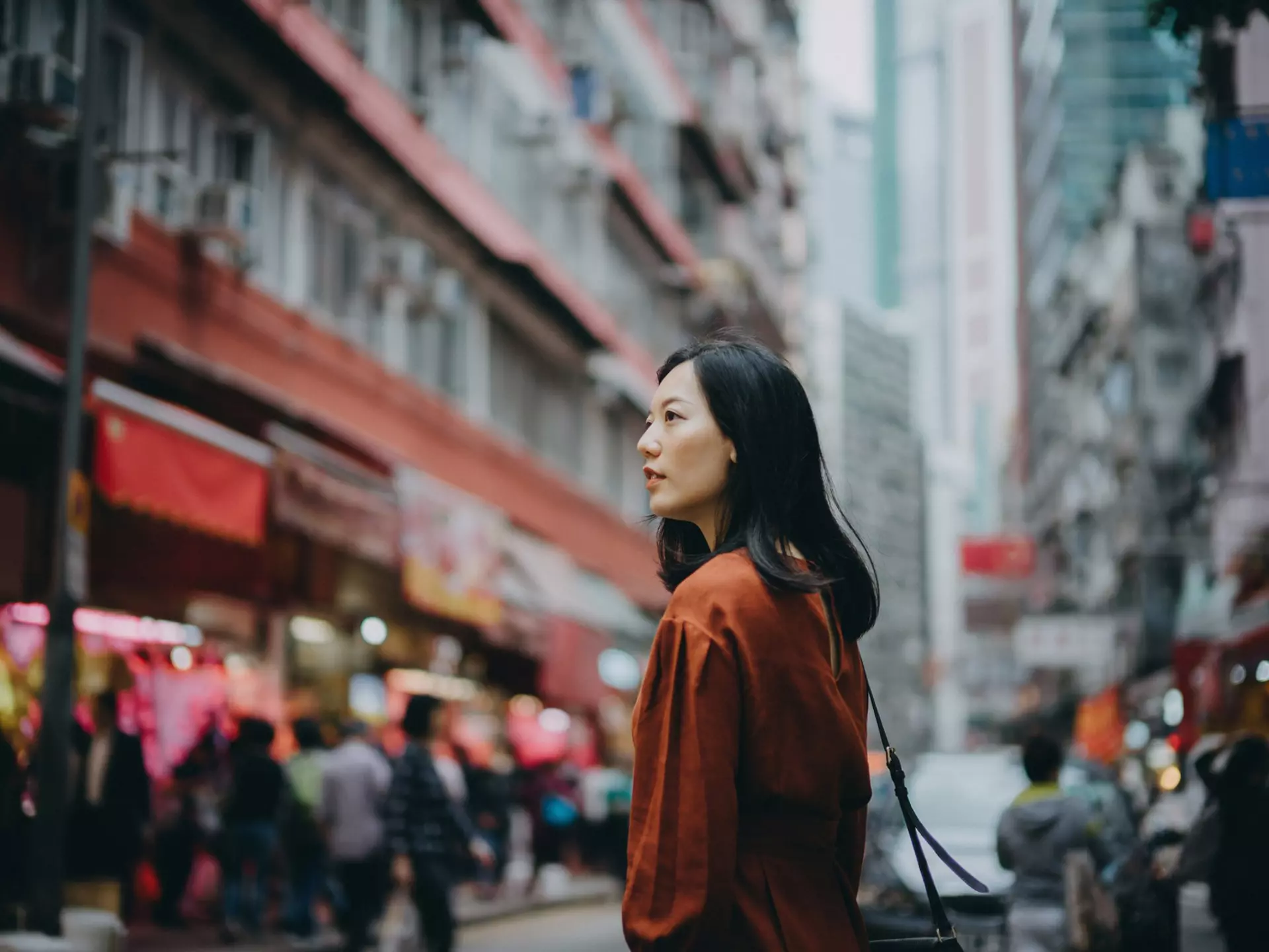 Young Asian woman exploring and strolling in local street market in Hong Kong
