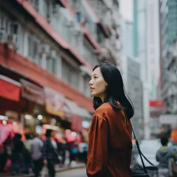 Young Asian woman exploring and strolling in local street market in Hong Kong