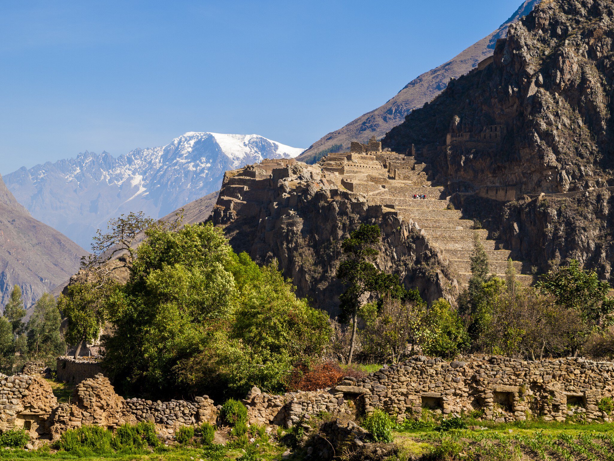 View of Ollantaytambo Ruins in the Sacred Valley, Peru with snowtopped mountains beyond