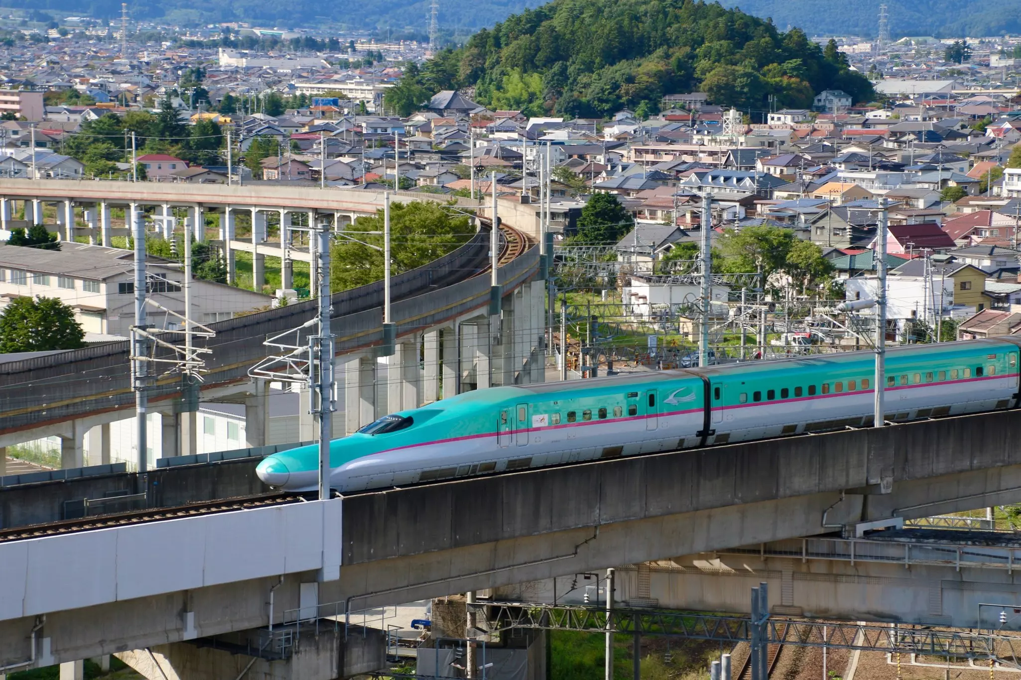 Shinkansen running through the urban landscape in Fukushima City, Japan.