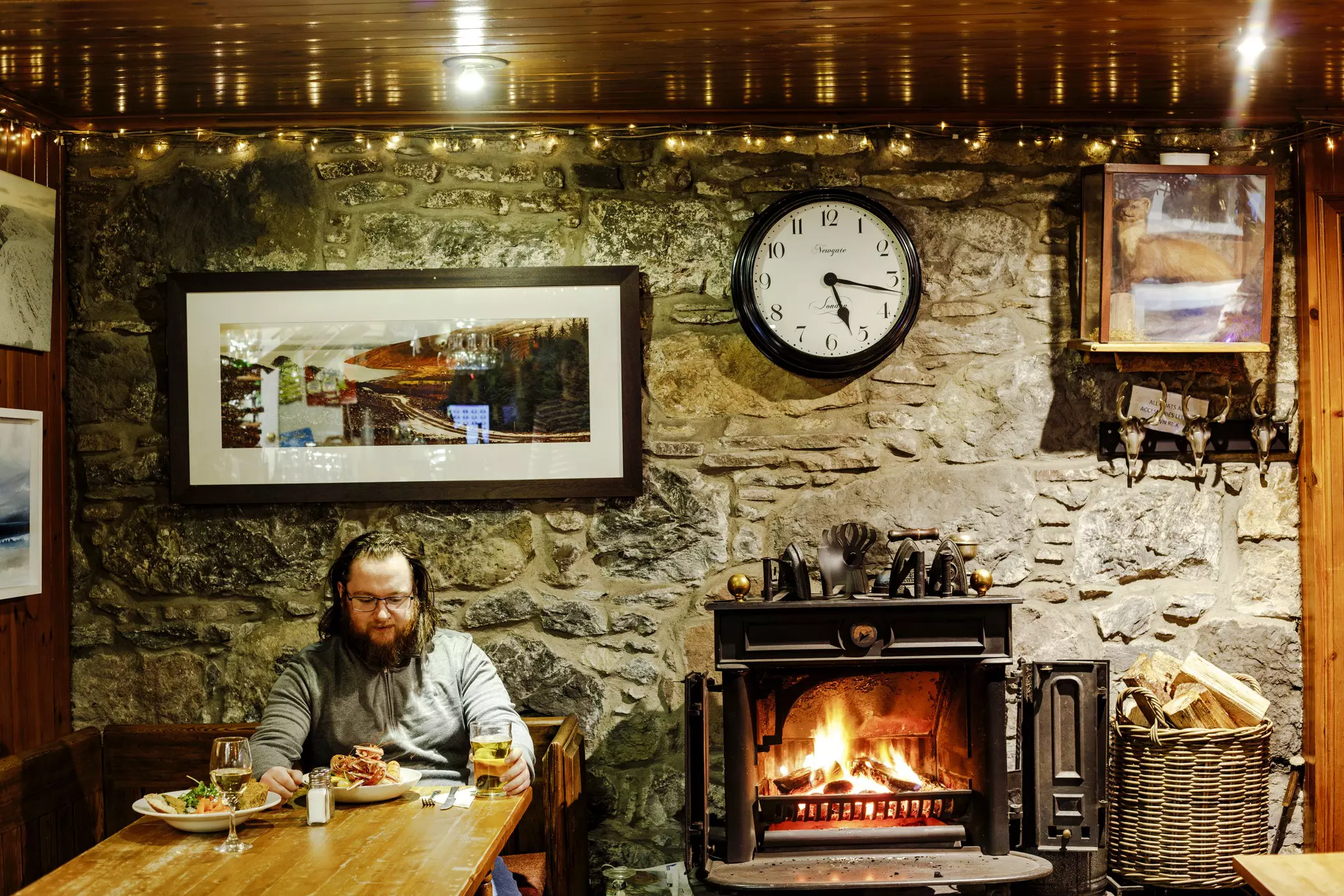 A traveler having a meal at the Applecross Inn on the NC500 driving route in Scotland.