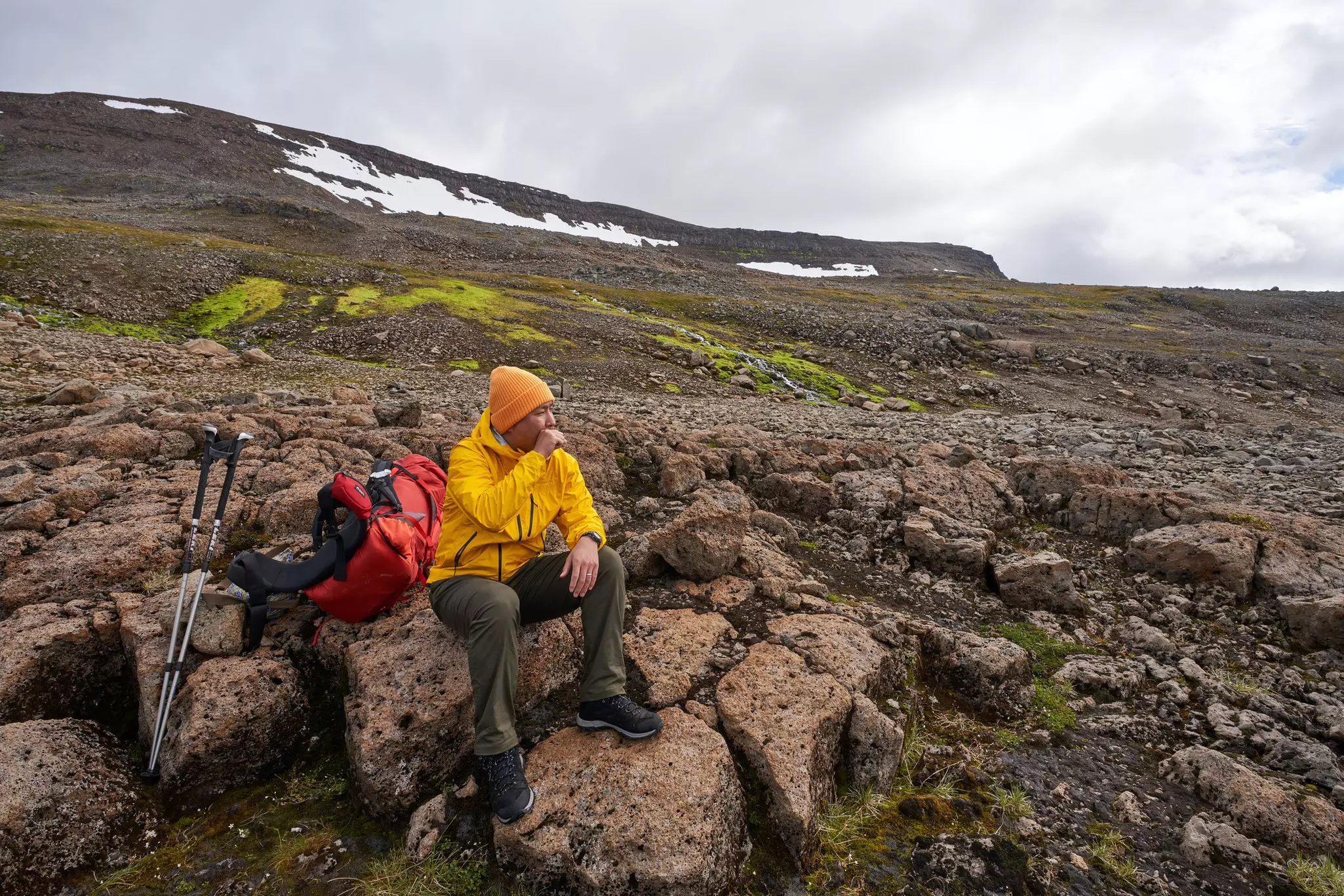 A hiker taking a break on a rocky landscape