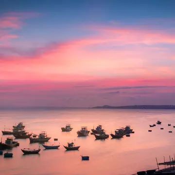 Elevated view of boats in bay at sunset, Mui Ne, Phan Thiet, Vietnam