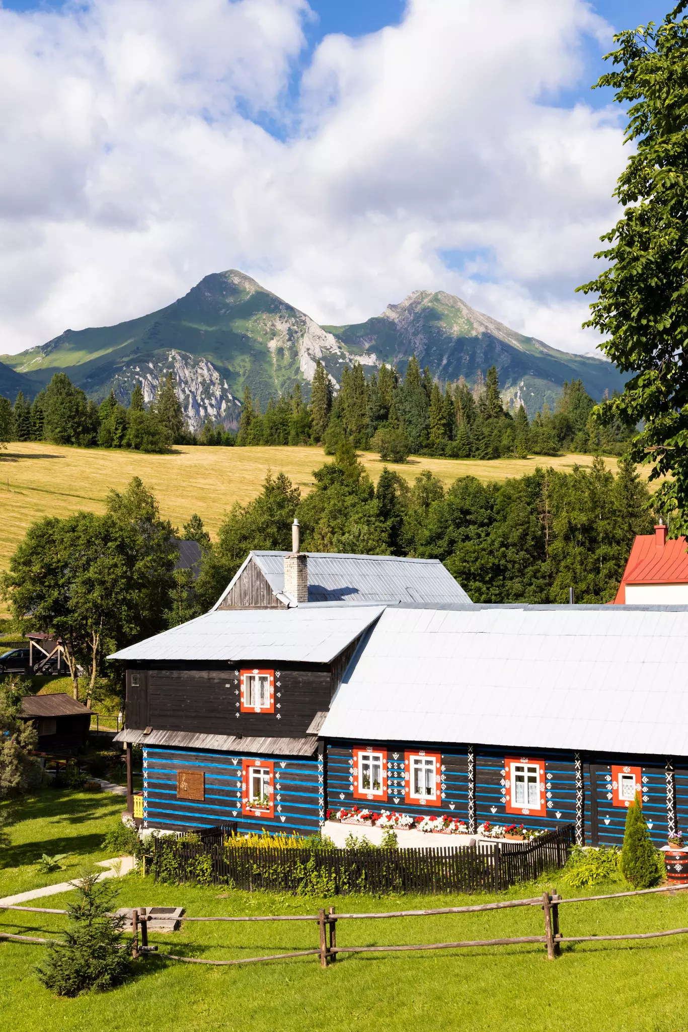 Red and blue painted house in the mountains under the Belianske Tatras