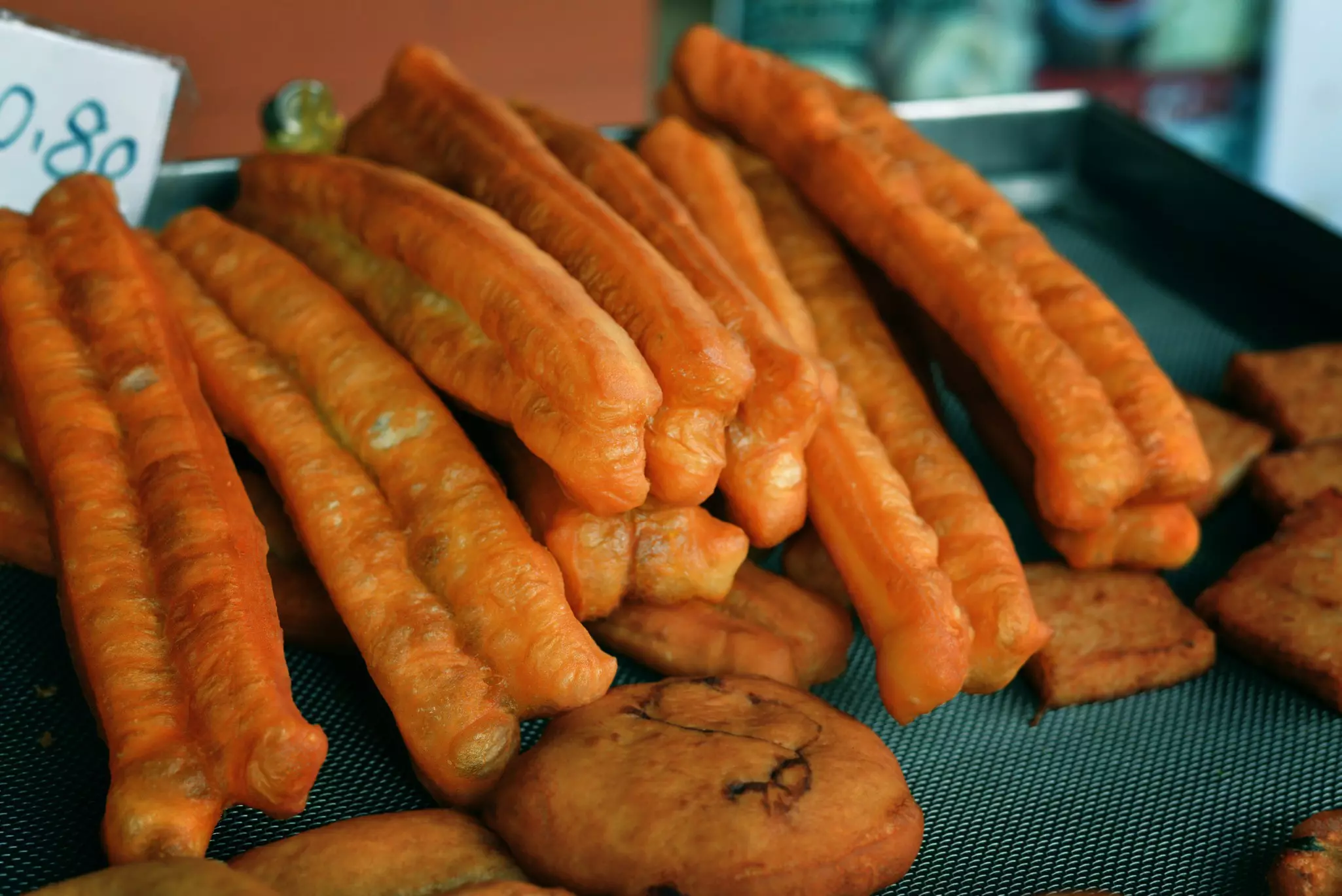 Two large cans of Saltbox Brewery's Crustacean Elation Ale sitting side-by-side on a bar table.